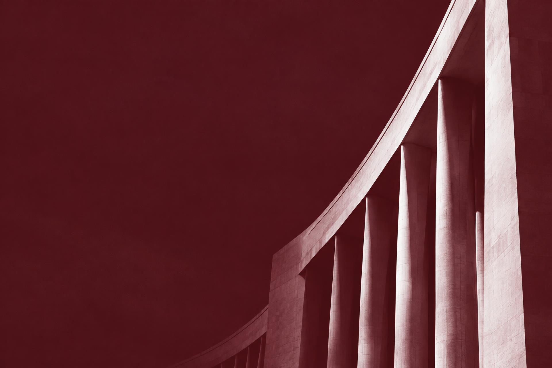 Sculptural white architecture in burgundy tones